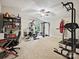 Spacious home gym equipped with various exercise machines and a ceiling fan at 1140 Randall Ct, Concord, NC 28025