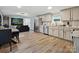 Open-concept kitchen with stainless steel appliances, hardwood floors and seamless transition to living area at 1140 Randall Ct, Concord, NC 28025