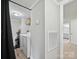 Laundry area featuring modern washer and dryer units, complemented by convenient shelving at 1140 Randall Ct, Concord, NC 28025