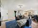 Bright living room featuring hardwood floors, modern lighting, and an open floor plan to the kitchen at 1140 Randall Ct, Concord, NC 28025
