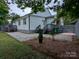 Backyard featuring a small deck with stairs, a gravel area, and green space at 11419 Leadenhall Ln, Charlotte, NC 28262