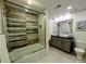 Bathroom with double sink, walk-in shower and natural stone shower wall at 11419 Leadenhall Ln, Charlotte, NC 28262
