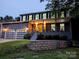 Charming two-story home featuring an attached two-car garage and a welcoming front porch with a yellow door at 11419 Leadenhall Ln, Charlotte, NC 28262