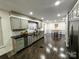 Kitchen with stainless steel appliances, wood flooring and dining area at 11419 Leadenhall Ln, Charlotte, NC 28262
