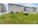 Spacious backyard featuring a well-maintained lawn, a white picket fence, and a charming patio set at 1220 Kent Downs Sw Ave, Concord, NC 28027