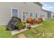 Relaxing patio with outdoor seating, a grill with cover, and a manicured lawn in the backyard at 1220 Kent Downs Sw Ave, Concord, NC 28027