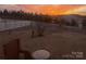Backyard at twilight featuring a white picket fence and a birdbath at 1220 Kent Downs Sw Ave, Concord, NC 28027