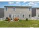 Large backyard featuring patio with outdoor furniture, grill, and a well-maintained lawn with fencing at 1220 Kent Downs Sw Ave, Concord, NC 28027