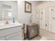 Well-lit bathroom with a single sink vanity, decorative cabinet, and shower with a bird-themed curtain at 1220 Kent Downs Sw Ave, Concord, NC 28027