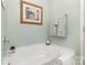 Clean bathtub with gray towels hangs on the wall and a painting above at 1220 Kent Downs Sw Ave, Concord, NC 28027