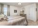 Cozy bedroom features a neutral color scheme, a dresser with a mirror, and soft natural light at 1220 Kent Downs Sw Ave, Concord, NC 28027