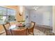 Cozy dining area with a round glass table, decorative chandelier, and natural light from the window at 1220 Kent Downs Sw Ave, Concord, NC 28027