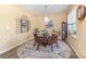 Bright dining room featuring a modern chandelier, round glass table, and decorative rug at 1220 Kent Downs Sw Ave, Concord, NC 28027