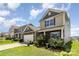 Landscaped front yard showcasing a charming two-story home with stone accents and inviting curb appeal at 1220 Kent Downs Sw Ave, Concord, NC 28027