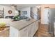 A kitchen island with granite countertops overlooks the living room in this open-concept home at 1220 Kent Downs Sw Ave, Concord, NC 28027