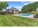 Large backyard with a swimming pool, pergola, and well-maintained lawn at 1236 James Farm Rd, Hickory, NC 28602