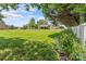 Large backyard featuring a covered patio, manicured lawn, and mature trees at 1236 James Farm Rd, Hickory, NC 28602