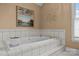 Relaxing bathtub with tile surround and garden view at 1236 James Farm Rd, Hickory, NC 28602