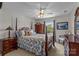 Traditional bedroom with a four-poster bed, patterned bedding, and natural light from the window at 1236 James Farm Rd, Hickory, NC 28602