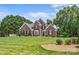 Beautiful brick home featuring lush green lawn, mature trees, and well-maintained landscaping at 1236 James Farm Rd, Hickory, NC 28602