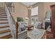 Spacious living room boasts high ceilings, fireplace, large windows, and elegant staircase at 1236 James Farm Rd, Hickory, NC 28602
