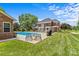 Backyard pool area with a grill, outdoor seating, and well-maintained lawn at 1236 James Farm Rd, Hickory, NC 28602