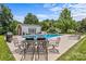 Backyard with a sparkling pool, poolhouse, and outdoor dining area at 1236 James Farm Rd, Hickory, NC 28602