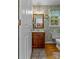 Charming powder room with floral wallpaper, wood vanity and brushed gold fixtures at 1236 James Farm Rd, Hickory, NC 28602