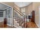 Elegant staircase leading to the second floor, adjacent to the well-lit living area at 1236 James Farm Rd, Hickory, NC 28602