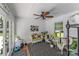 Bright sunroom with wicker furniture, a ceiling fan, and a view of the backyard at 1236 James Farm Rd, Hickory, NC 28602