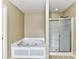 Bathroom featuring a soaking tub and glass enclosed shower at 14307 Hartwell Farm Dr, Charlotte, NC 28278