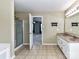 Bathroom featuring a double vanity sink, walk-in shower, and view into the bedroom at 14307 Hartwell Farm Dr, Charlotte, NC 28278