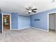 Bright bedroom featuring neutral carpet, a ceiling fan, and two entryways at 14307 Hartwell Farm Dr, Charlotte, NC 28278