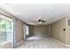 Large bedroom with neutral carpet, neutral walls, multiple windows, and a ceiling fan at 14307 Hartwell Farm Dr, Charlotte, NC 28278