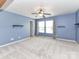 Spacious bedroom with plush carpeting, neutral paint, a ceiling fan, and bright, natural light at 14307 Hartwell Farm Dr, Charlotte, NC 28278