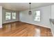 Open dining area with hardwood floors and modern light fixture at 14307 Hartwell Farm Dr, Charlotte, NC 28278