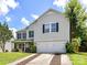 Traditional two-story home with lush green lawn and attached two car garage at 14307 Hartwell Farm Dr, Charlotte, NC 28278