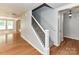 Inviting foyer featuring hardwood floors and an ornate staircase leading to the upper level at 14307 Hartwell Farm Dr, Charlotte, NC 28278