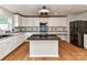 Stylish kitchen featuring an island with granite countertops and sleek appliances at 14307 Hartwell Farm Dr, Charlotte, NC 28278