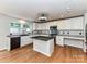 Well-lit kitchen with island, modern fixtures, and ample counter space at 14307 Hartwell Farm Dr, Charlotte, NC 28278