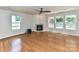 Cozy living room with a fireplace, hardwood floors, and large windows at 14307 Hartwell Farm Dr, Charlotte, NC 28278