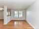 Living room area featuring hardwood floors, neutral walls, and large windows at 14307 Hartwell Farm Dr, Charlotte, NC 28278
