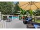 Outdoor deck with a clear view of the pool, lounge chairs, and tropical foliage at 1507 Breckenwood Dr, Rock Hill, SC 29732