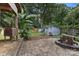 View of backyard showing patio, storage sheds, mature trees, and fire pit at 1507 Breckenwood Dr, Rock Hill, SC 29732