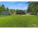 Large grassy backyard featuring mature trees and storage sheds at 1507 Breckenwood Dr, Rock Hill, SC 29732
