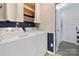 Well-organized laundry room features full sized washer and dryer set with a door leading to another part of the home at 1507 Breckenwood Dr, Rock Hill, SC 29732