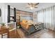 Charming main bedroom boasts a wooden accent wall, ceiling fan, a cowhide blanket, and a decorative rug at 1507 Breckenwood Dr, Rock Hill, SC 29732