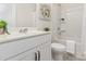 This is a well-lit bathroom with a single sink vanity, toilet, and shower-tub combo at 1514 Starmount Cove Ln, Charlotte, NC 28210