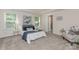 Beautiful bedroom featuring a king-size bed with a blue comforter, side tables, and two windows at 1514 Starmount Cove Ln, Charlotte, NC 28210