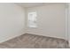 Neutral walls, carpeted flooring, and a window accentuate this bedroom at 1514 Starmount Cove Ln, Charlotte, NC 28210